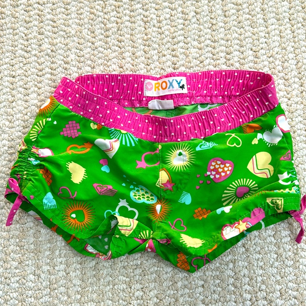 Roxy Girls Swim Shorts in Vibrant Green and Pink with scrunch side tie on leg.
